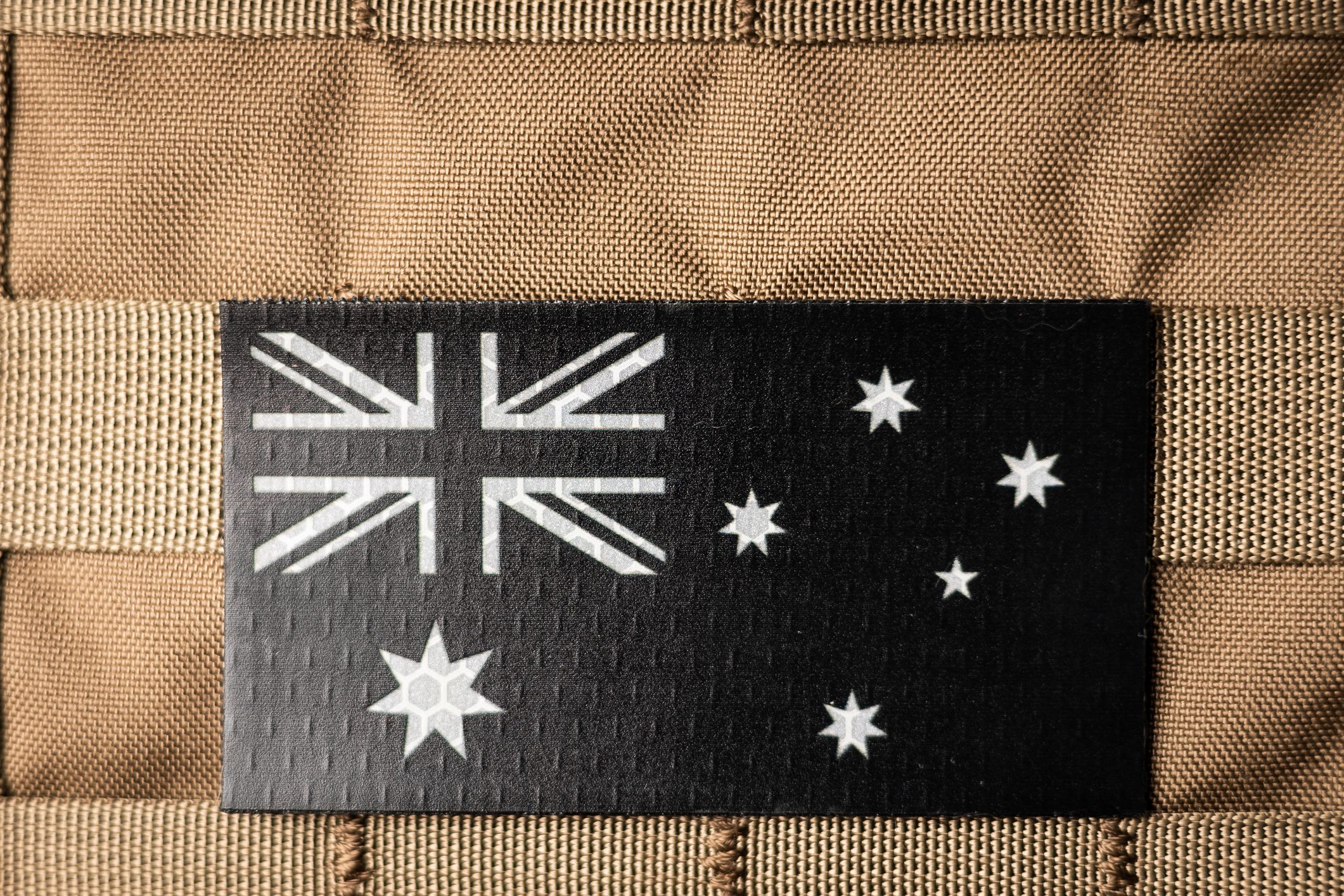 Black subdued Australian flag patch on tan gear