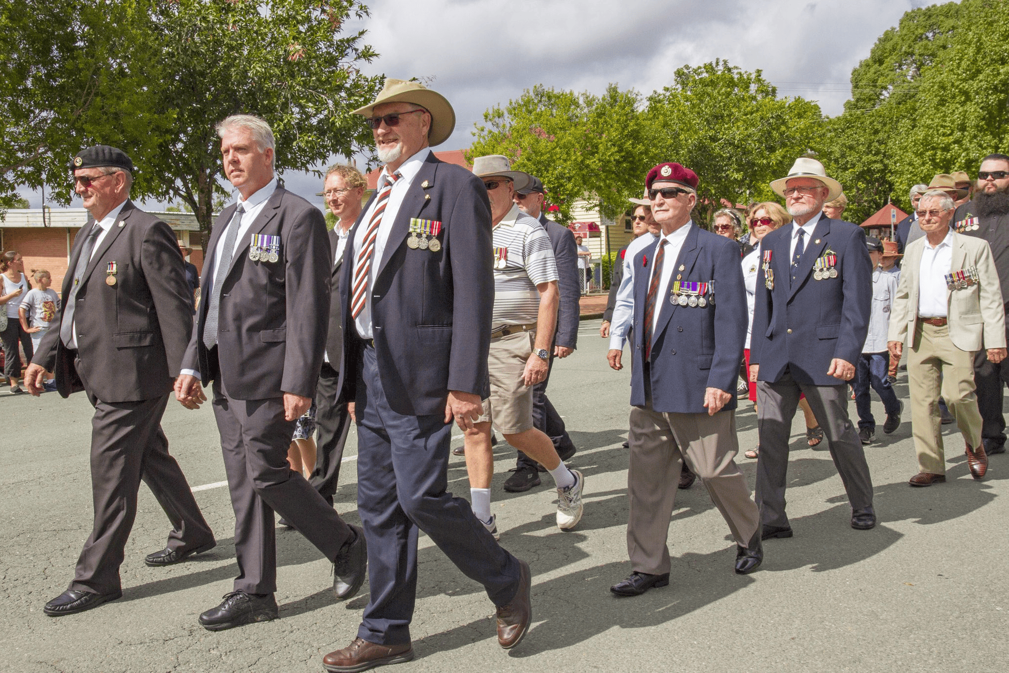 Veterans marching in parade wearing medals