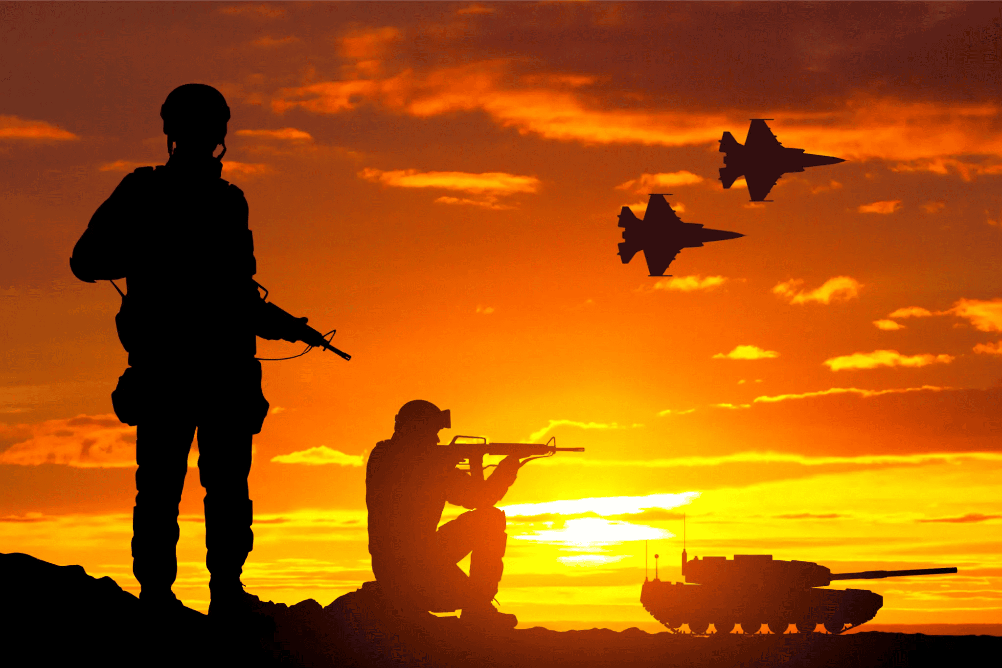 Silhouetted soldiers, tank, and jets at sunset